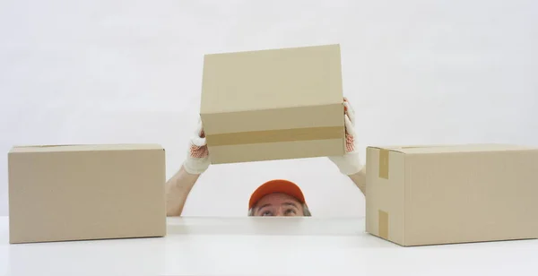Tanınmayan bir depo işçisi üst raftan bir karton kutu alıyor. Kırmızı 'da 6K video çekimi — Stok fotoğraf