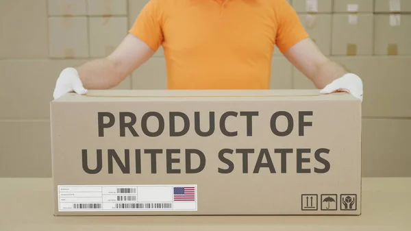 Warehouse worker and big box with PRODUCT OF UNITED STATES printed text