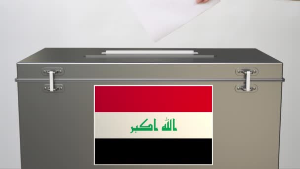 Hand zetten papier stembiljet in stembus met vlag van Irak. Verkiezingsgerelateerde clip — Stockvideo
