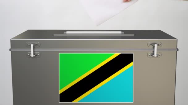 Putting paper ballot into ballot box with flag of Tanzania. Voting related clip — Stock Video