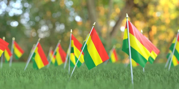 Маленькі національні прапори Болівії в траві. Святкування пов'язане з 3D рендерингом — стокове фото