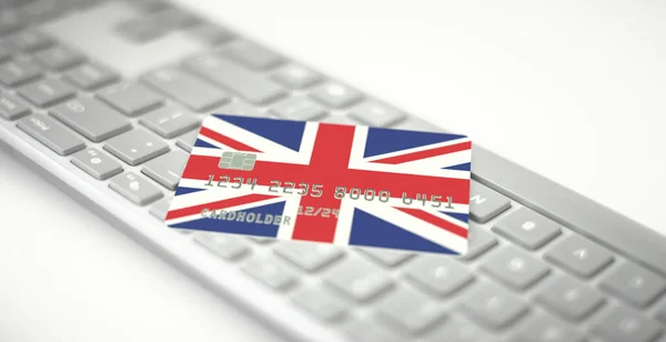 Plastová bankovní karta zobrazující vlajku Spojeného království na klávesnici počítače. Fiktivní čísla — Stock fotografie