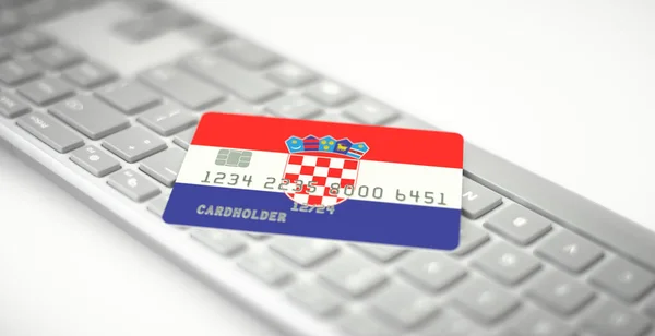 Plastová bankovní karta zobrazující vlajku Chorvatska na klávesnici počítače. Fiktivní čísla — Stock fotografie