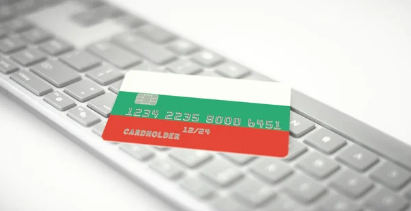 Tarjeta bancaria de plástico que representa la bandera de Bulgaria en el teclado de la computadora. Números de ficción — Foto de Stock
