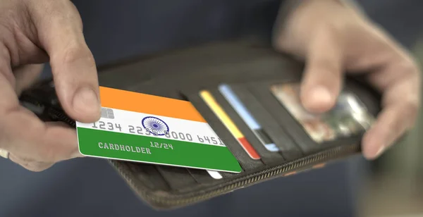Man pulls plastic bank card with flag of India out of his wallet, fictional card number — Stock Photo, Image