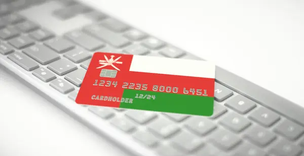 Tarjeta bancaria de plástico que representa la bandera de Omán en el teclado de la computadora. Números de ficción — Foto de Stock