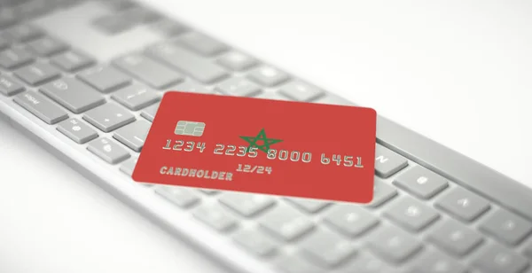 Plastic bank card depicting flag of Morocco on computer keyboard. Fictional numbers — Stock Photo, Image