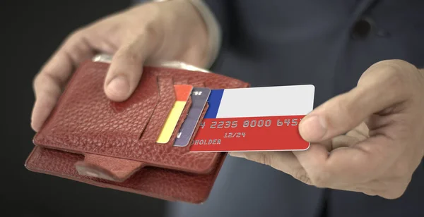 Мужчина вытаскивает кредитку с флагом Чили из бумажника, номер вымышленной карты — стоковое фото