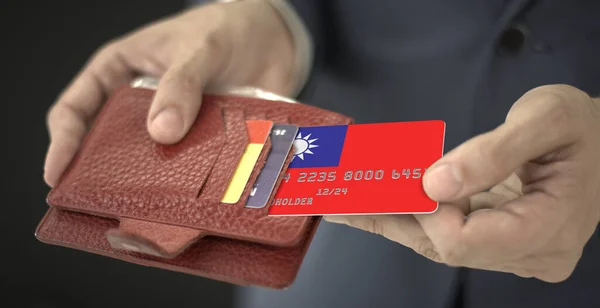 Homem puxa cartão de crédito com bandeira de Taiwan fora de sua carteira, número de cartão fictício — Fotografia de Stock