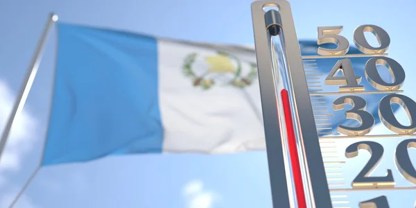 Thermometer shows high air temperature against blurred flag of Guatemala. Hot weather forecast related 3D rendering — Stock Photo, Image