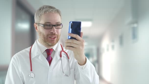 Medicul își folosește telefonul pentru un apel video de la un pacient — Videoclip de stoc