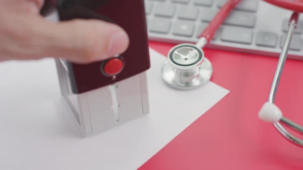 PUBLIC HEALTH EMERGENCY stamp on the paper, doctors workplace — Stock Video