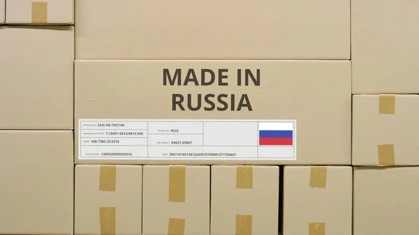 MADE IN RUSSIA text and flag label on the carton in a storage — Stock Photo, Image