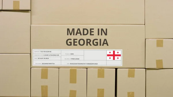 Caja de cartón con texto impreso MADE IN GEORGIA entre otros cuadros —  Fotos de Stock