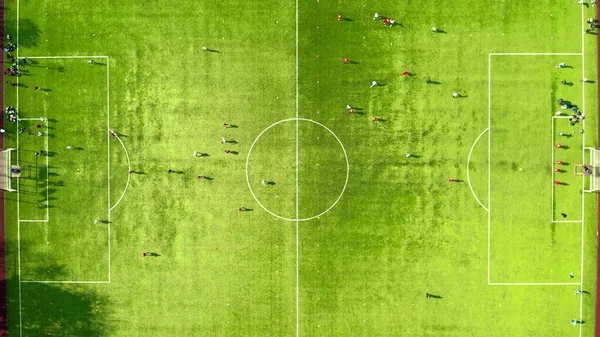 緑のサッカー場でのサッカー選手のトレーニングの空中トップダウンショット — ストック写真