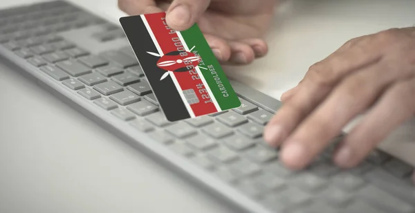 El hombre paga en línea con tarjeta de crédito con la bandera de Kenia. Números de ficción — Foto de Stock