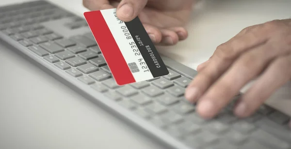 Hombre desconocido paga en línea con tarjeta bancaria de plástico con la bandera de Yemen. Números de ficción — Foto de Stock