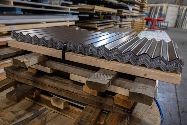 A stack of corrugated roofing sheets on wooden pallet for delivery to customers