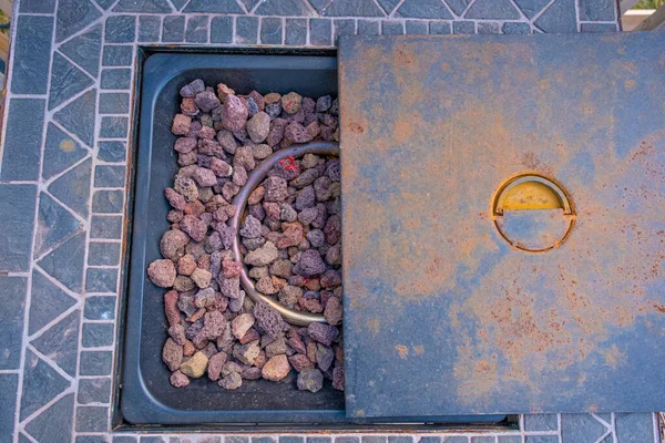 Table Fire Pit with rocks on outside deck patio