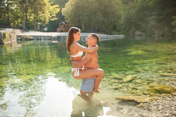 アクティブな若いカップルで夏の暑い日立って川を低温と水中歩行 — ストック写真