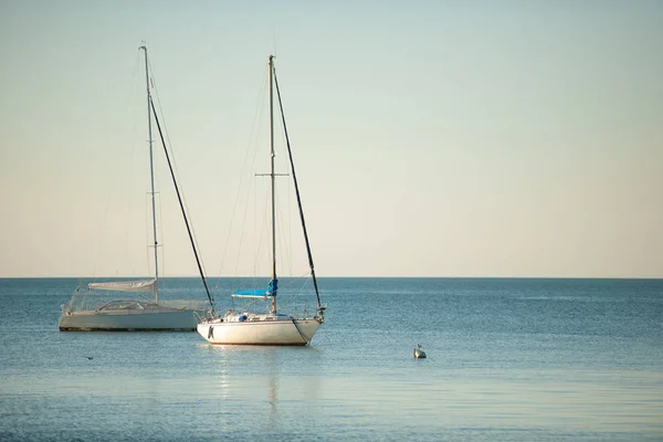 stock image sail Boats anchored near coast on a calm ocean sea