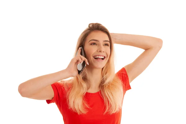Beautiful young woman in red t shirt speak on a smart phone isol — Stock Photo, Image