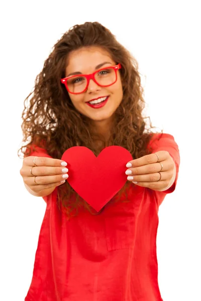 Mulher bonita em vermelho segurando um coração para o dia dos namorados — Fotografia de Stock