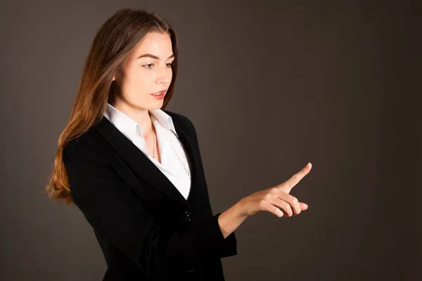 Attractive young business woman pressing virtual button over gra — Stock Photo, Image