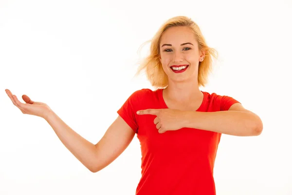 Attractive beautiful young blonde woman pointing into copyspace — Stock Photo, Image