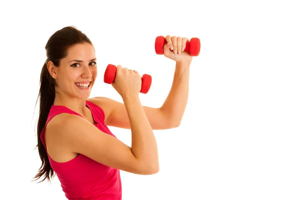 Active young woman wprkout with dumbbells in a fitness gym Royalty Free Stock Images