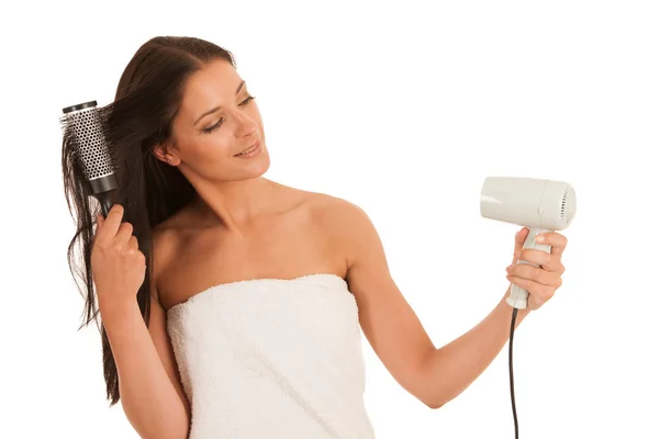 Beautiful young woman drying hair with hair dryer isolated over — Stock Photo, Image