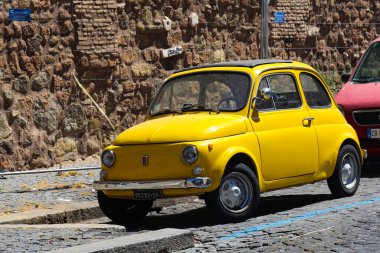 Roma, İtalya - 30 Haziran 2019: caddeye park edilmiş şirin sarı retro Fiat. İtalyan klasik arabası.