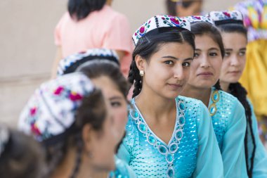 KHIVA, UZBEKISTAN - AUGUST 26, 2018: Folk dancers performs traditional dance at local festivals. clipart