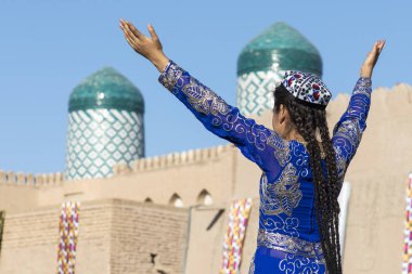 Folk dancers performs traditional dance at local festivals in Khiva, Uzbeksitan. clipart