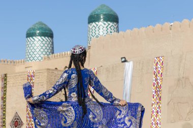Folk dancers performs traditional dance at local festivals in Khiva, Uzbeksitan. clipart