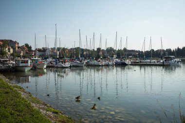 RYN, WARMIA-MASURIA PROVINCE / POLAND - JULY 31, 2018: Marina and pier on Rynskie lake, town of Ryn. clipart