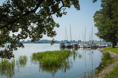 RYN, WARMIA-MASURIA PROVINCE / POLAND - JULY 31, 2018: Marina and pier on Rynskie lake, town of Ryn. clipart