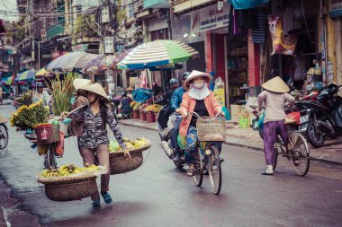 HAI PHONG, VIETNAM - NOVEMBER 12, 2018: People at busy morning street in Hai Phong, Vietnam.  clipart