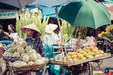 HANOI, VIETNAM - NOVEMBER 16, 2018 : Fresh vegetables and fruits in traditional street market in Hanoi, Vietnam. clipart