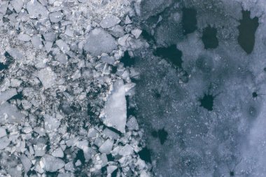 Glacier Lagoon with icebergs from above. Aerial View. Cracked Ice from drone view. Background texture concept.