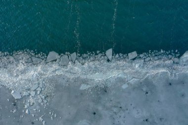 Glacier Lagoon with icebergs from above. Aerial View. Cracked Ice from drone view. Background texture concept.