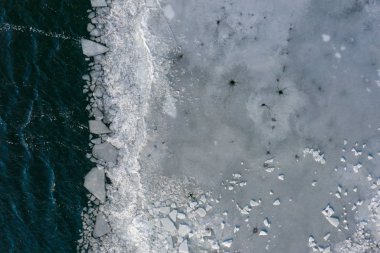 Glacier Lagoon with icebergs from above. Aerial View. Cracked Ice from drone view. Background texture concept.