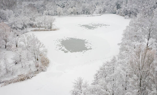 Aerial view of winter beautiful landscape with trees covered with hoarfrost and snow. Winter scenery from above. Landscape photo captured with drone.