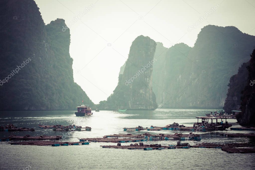 Rock islands near floating village in Halong Bay, Vietnam, South