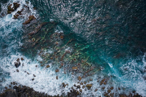 Aerial view to ocean waves. Blue water background. Photo made fr
