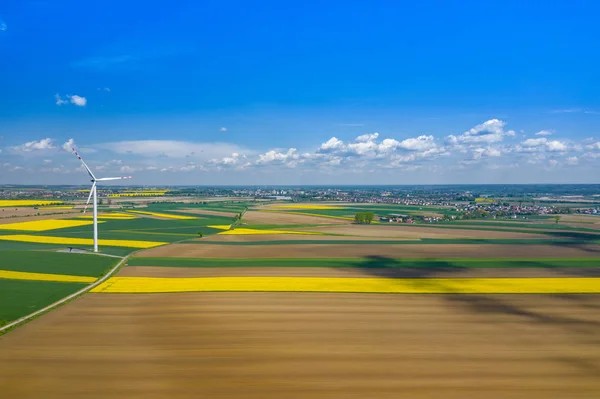 Aerial view of wind turbine. Rapeseed blooming. Windmills and ye — Stock Photo, Image