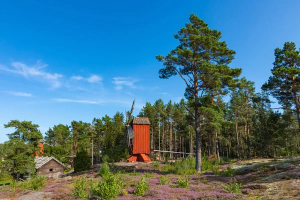 Molino de viento de madera roja en un antiguo paisaje rural vintage en Aland es — Foto de Stock