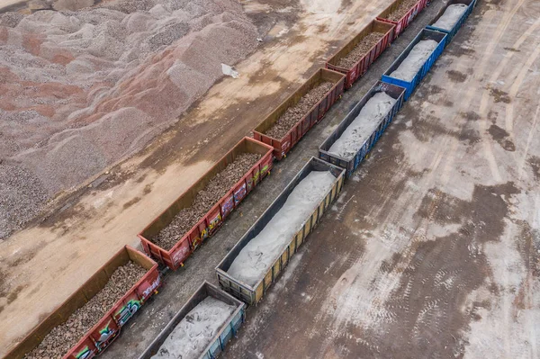 Open Pit Mine Top View. Aerial view of industrial mineral open pit mine. Opencast mining. Factory plant producing sand materials for construction industry.