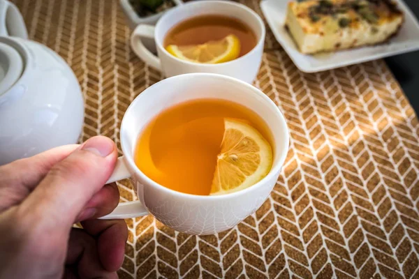Dietary breakfast tea with lemon in white cup and dessert casserole