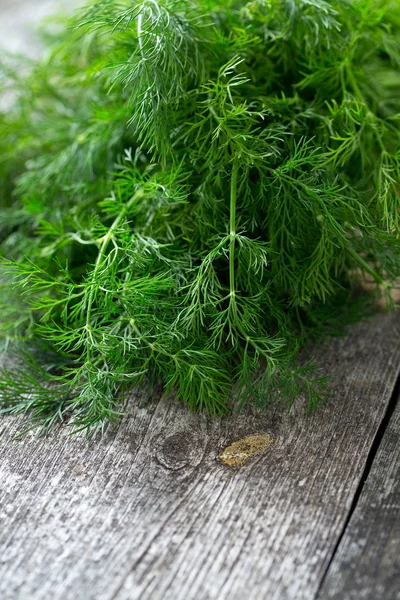 bunch of dill on wooden surface